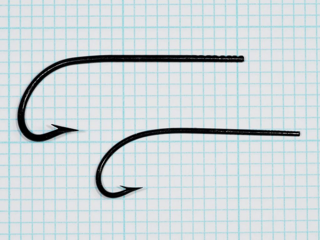Allcock Chestertown 667 hooks — side profile of No. 2 and No. 4 specimens on measurement grid showing tapered blind eye and sproat bend