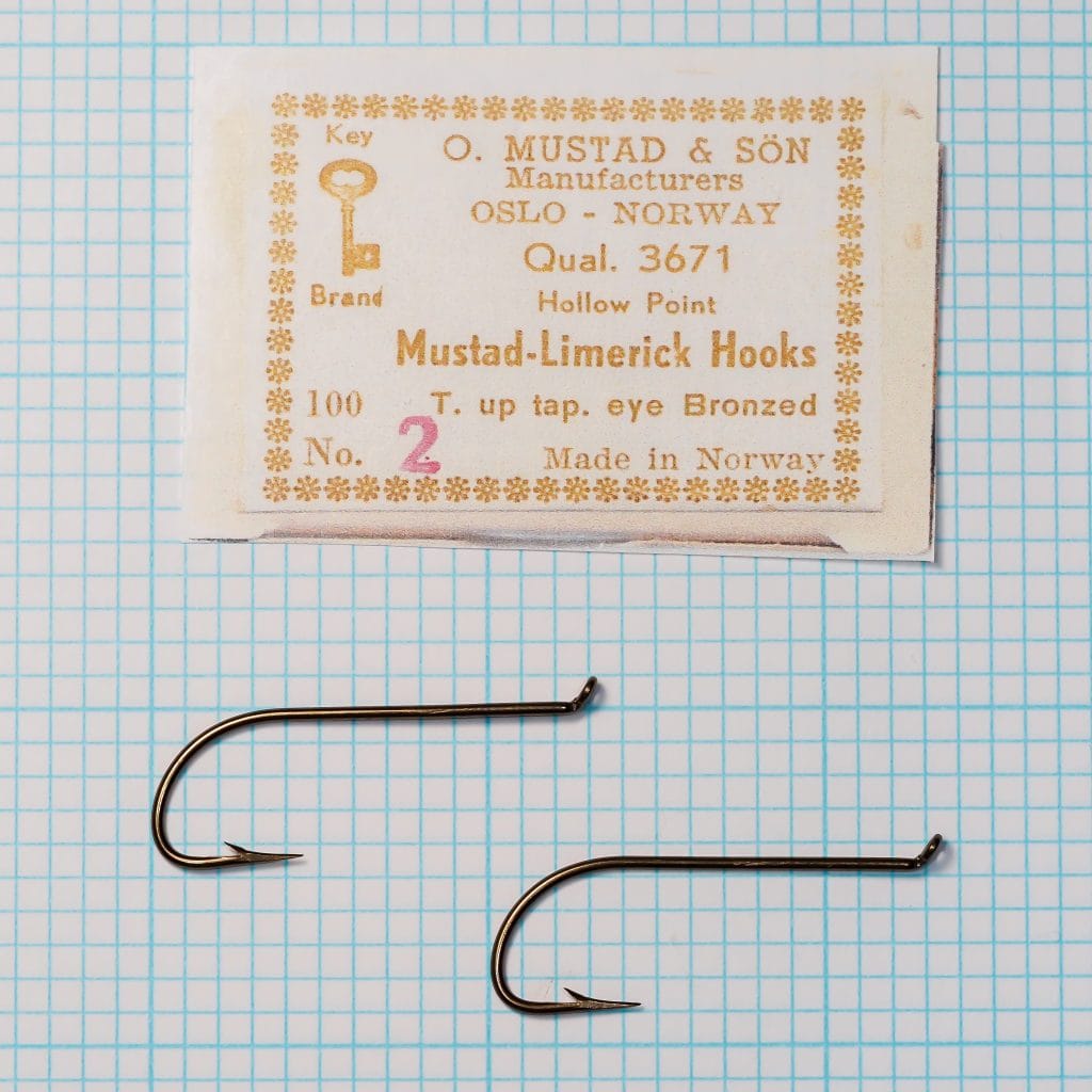 Mustad Quality 3671 box label with two No. 2 hooks on a measurement grid.