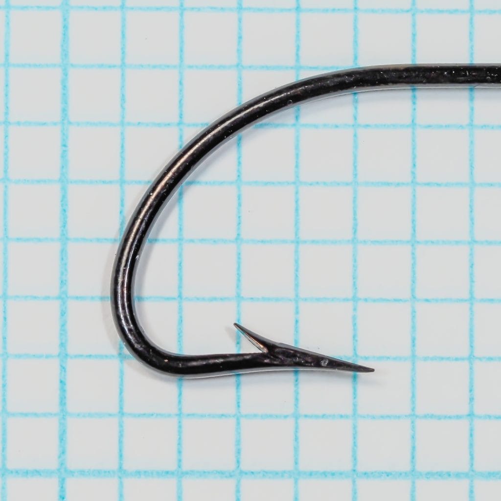 Mustad 7111B Limerick — point detail showing near-straight taper geometry and barb positioning — size 1/0 — black japanned finish