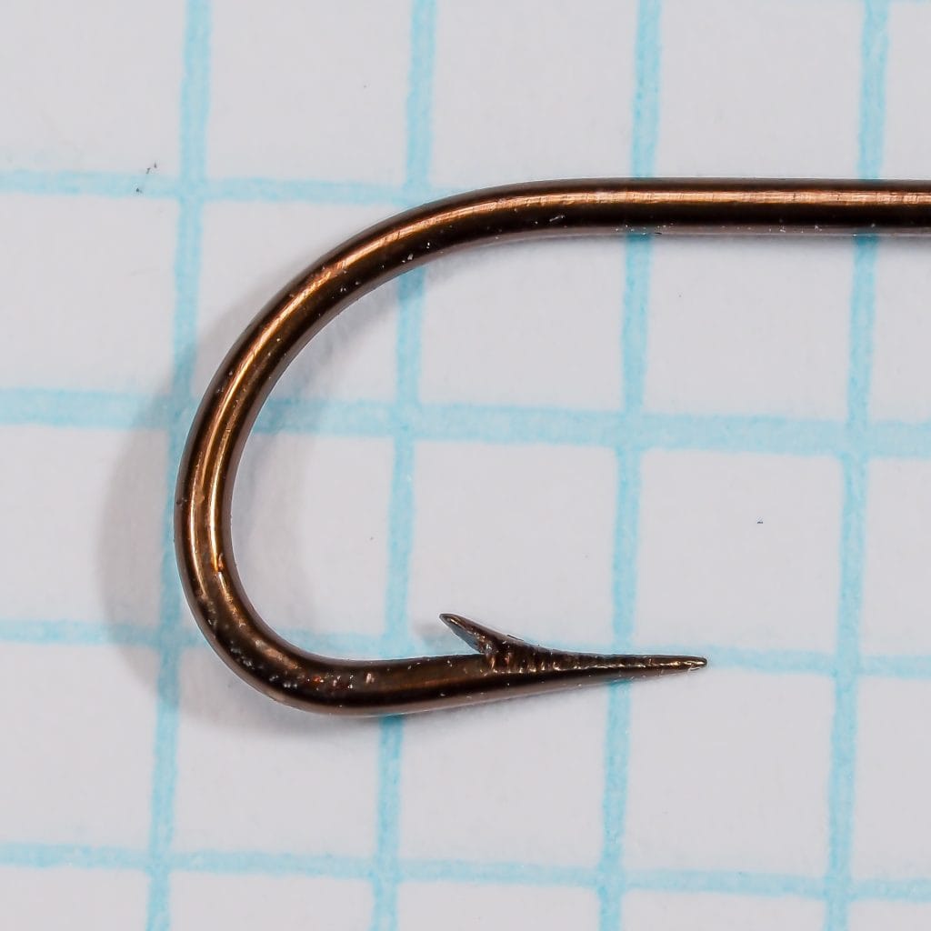 Edgar Sealey & Sons S 2015 bronzed Kirby bend fishhook displayed against grid background