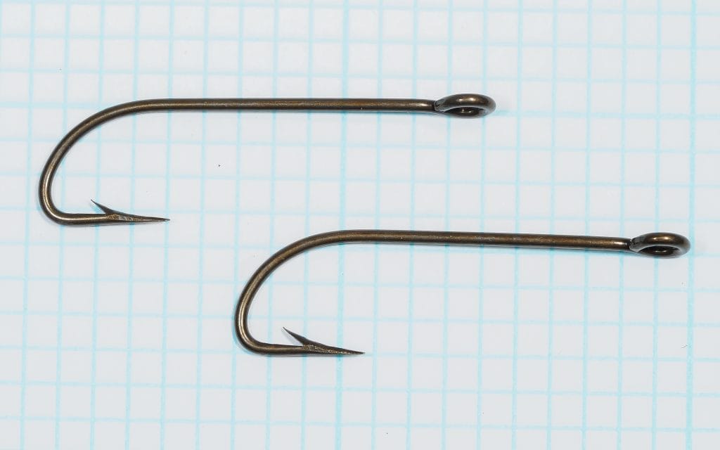 Mustad 8323 Hook — two size No. 5 ringed Limerick streamer hooks on measurement grid — showing full profile and point geometry — bronzed finish