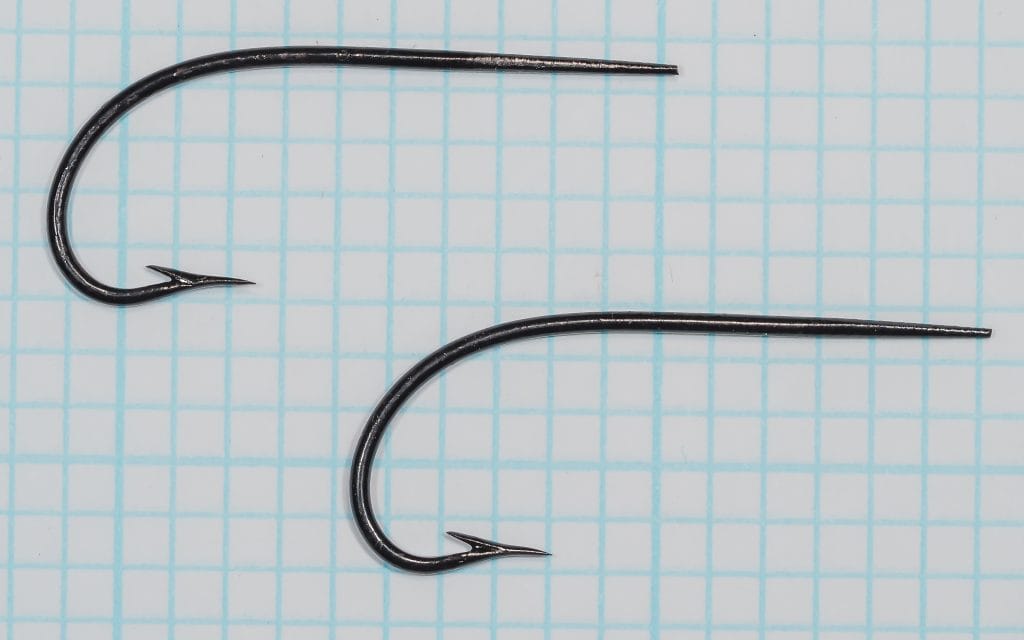 Harrison Celebrated Dublin Limerick Hooks size No. 2 — two black japanned hooks showing complete side profile and bend geometry — on 1/10-inch measurement grid