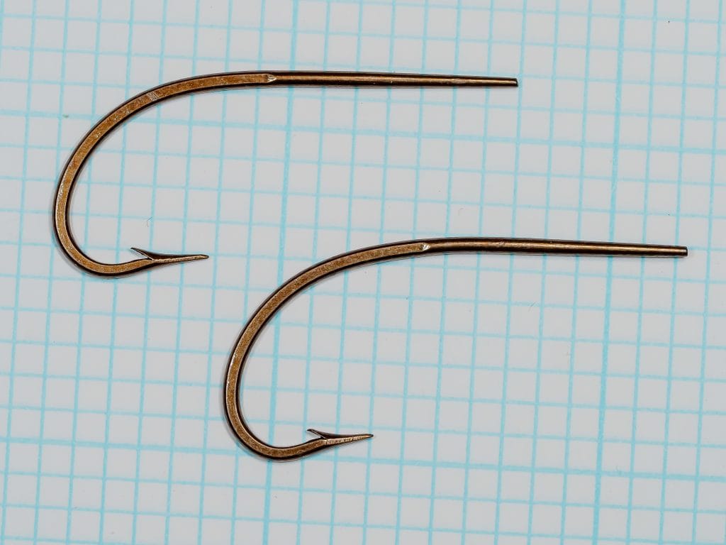Harrison Bartleet 2989 — two hooks positioned on 1/10-inch measurement grid, lateral view, bronzed finish visible