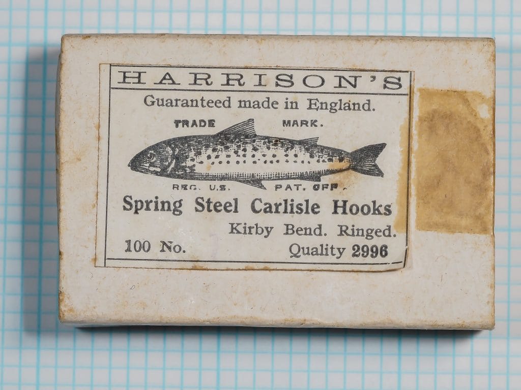 Harrison's Quality 2996 Spring Steel Carlisle fishhook packaging — original cardboard box with printed label, Kirby bend ringed eye wet fly hook, c.1925-1945, showing trade mark trout illustration and period letterpress printing
