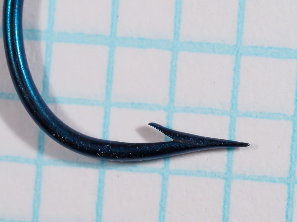 Harrisons Carlisle Hook size 1/0 — side profile showing bend depth, barb angle, and point geometry — blued finish detail