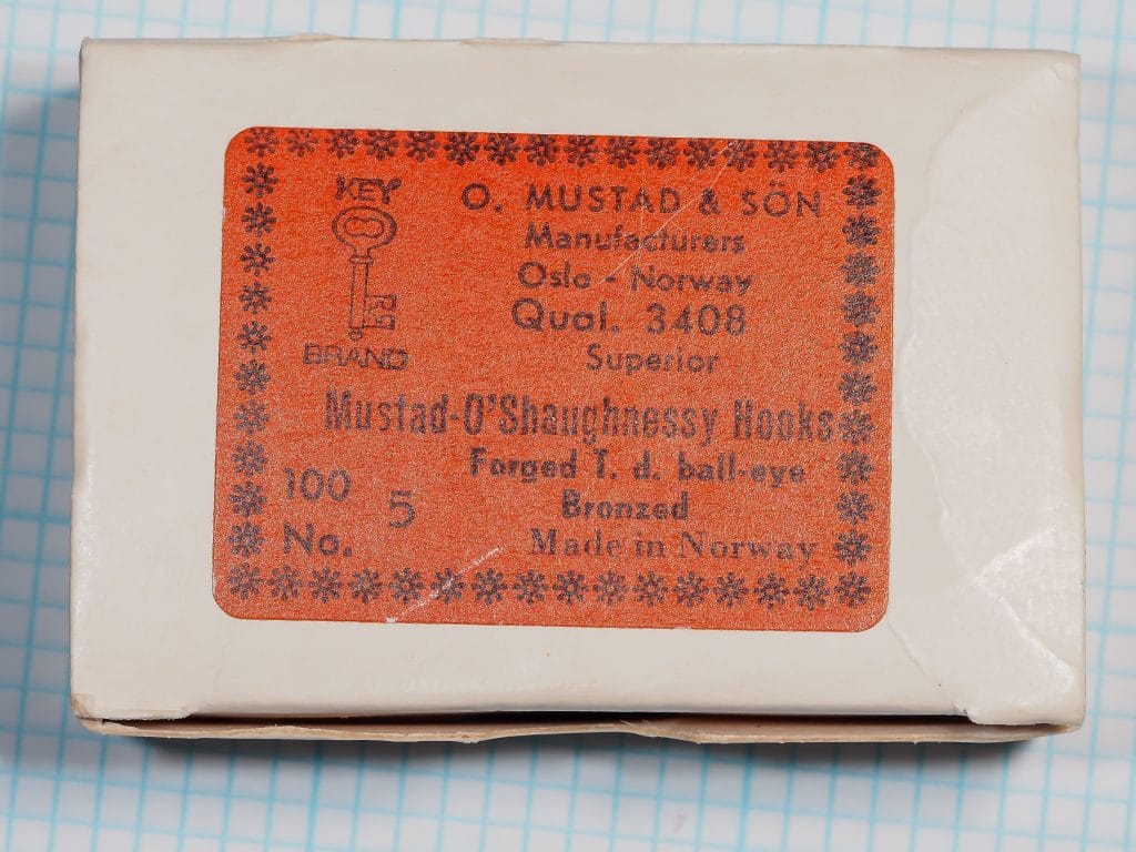 Mustad 3408 — vintage orange label on cardboard box — Size 5 — Key Brand trademark and eight-line label format showing O'Shaughnessy pattern designation