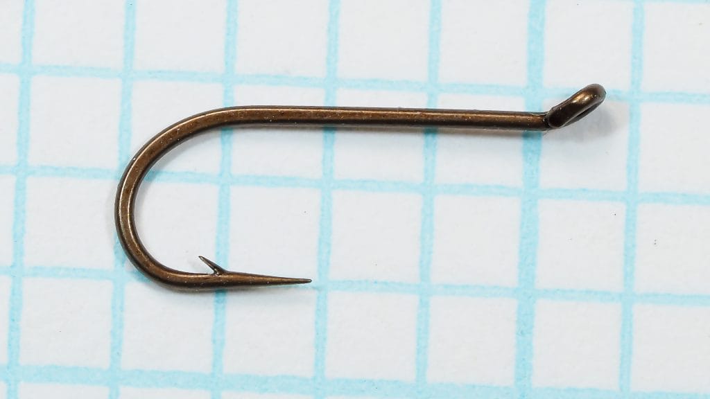 Allcocks W172 hook — full side profile showing sproat bend, turned-up tapered eye, and bronzed finish — size 14 — photographed on measurement grid