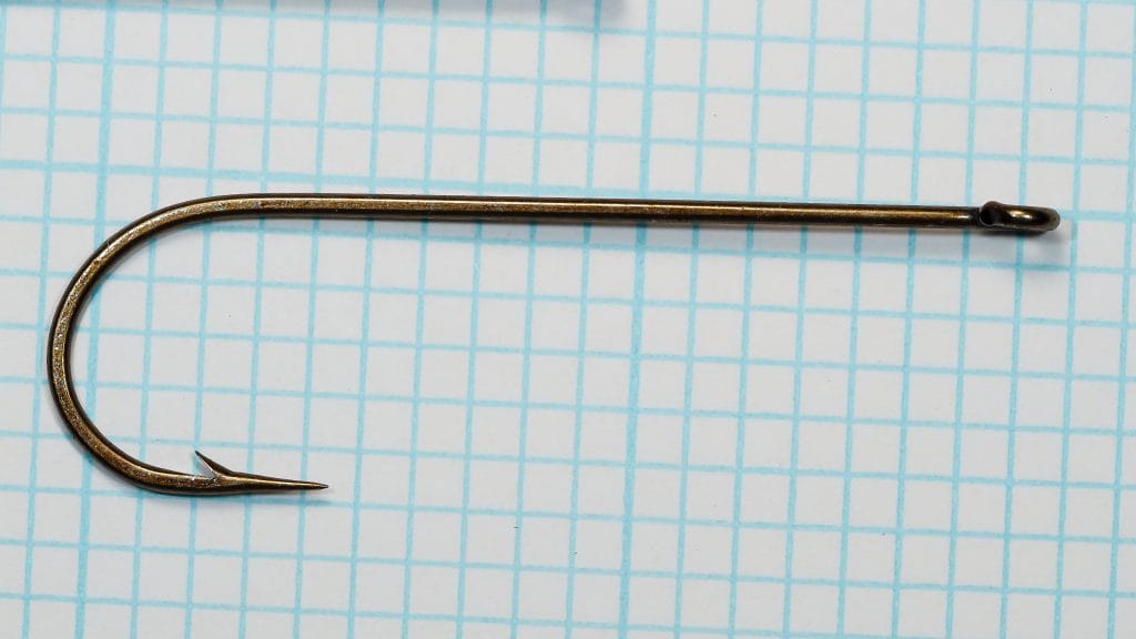 Allcock Z174 3X Long — single hook side profile showing Sproat bend and straight ring eye — size 1/0 — bronzed finish on measurement grid