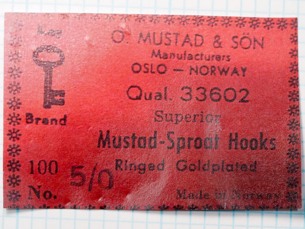 Mustad 33602 box label — red cardboard with snowflake border and Key Brand logo — vintage packaging with printed specs