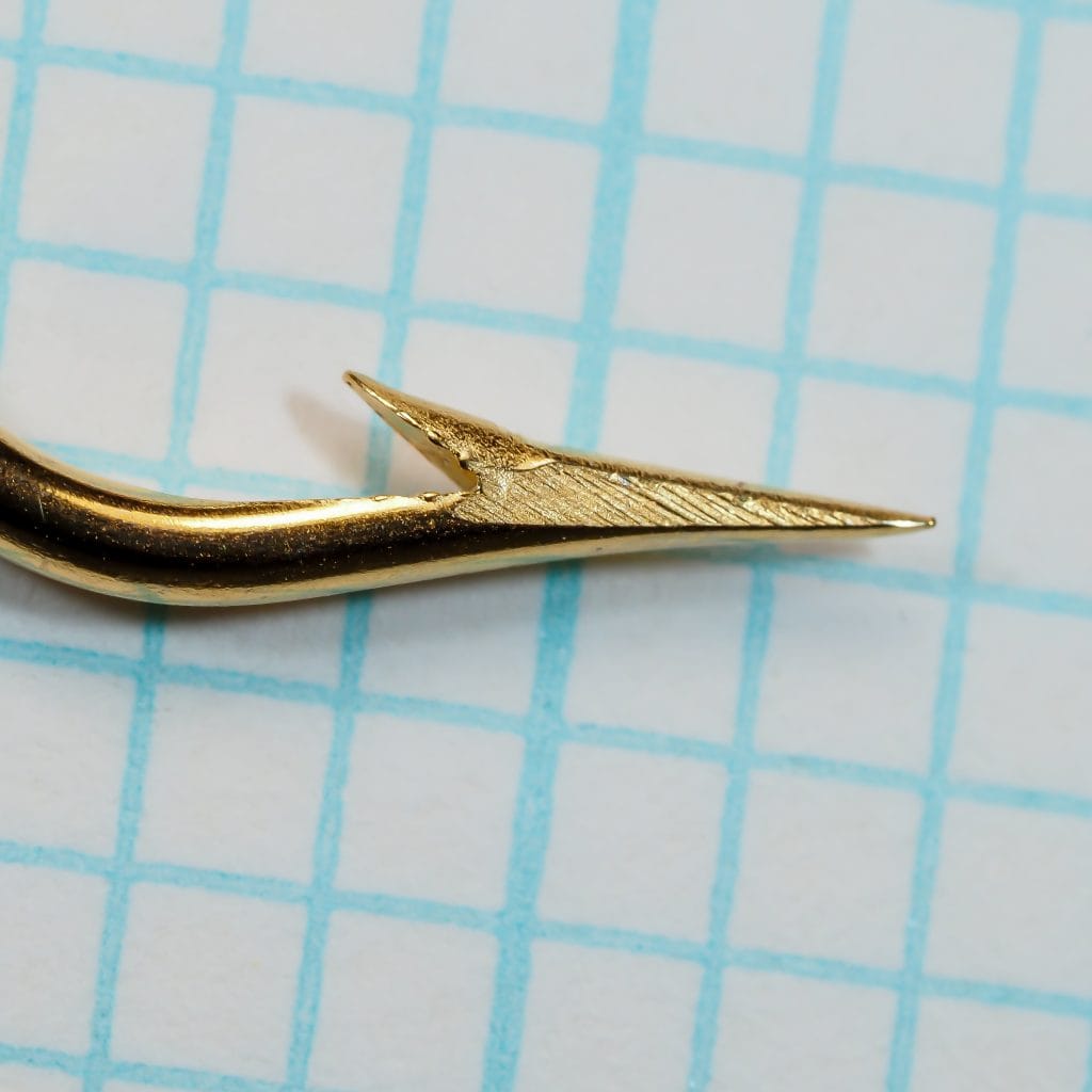 Mustad 33602 hook point — magnified view showing superior-point geometry — barb and taper detail