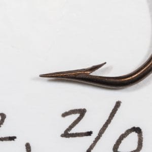 Mustad 3371 — full hook on grid with printed specimen label showing size notation — side view — bronzed finish