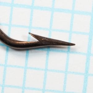 Mustad 3371 — point and barb extreme close-up showing concave geometry — superior-point profile — bronzed finish