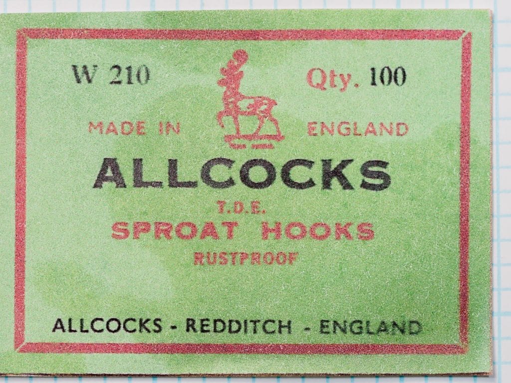 Close-up of Allcocks W210 box label showing text and deer logo