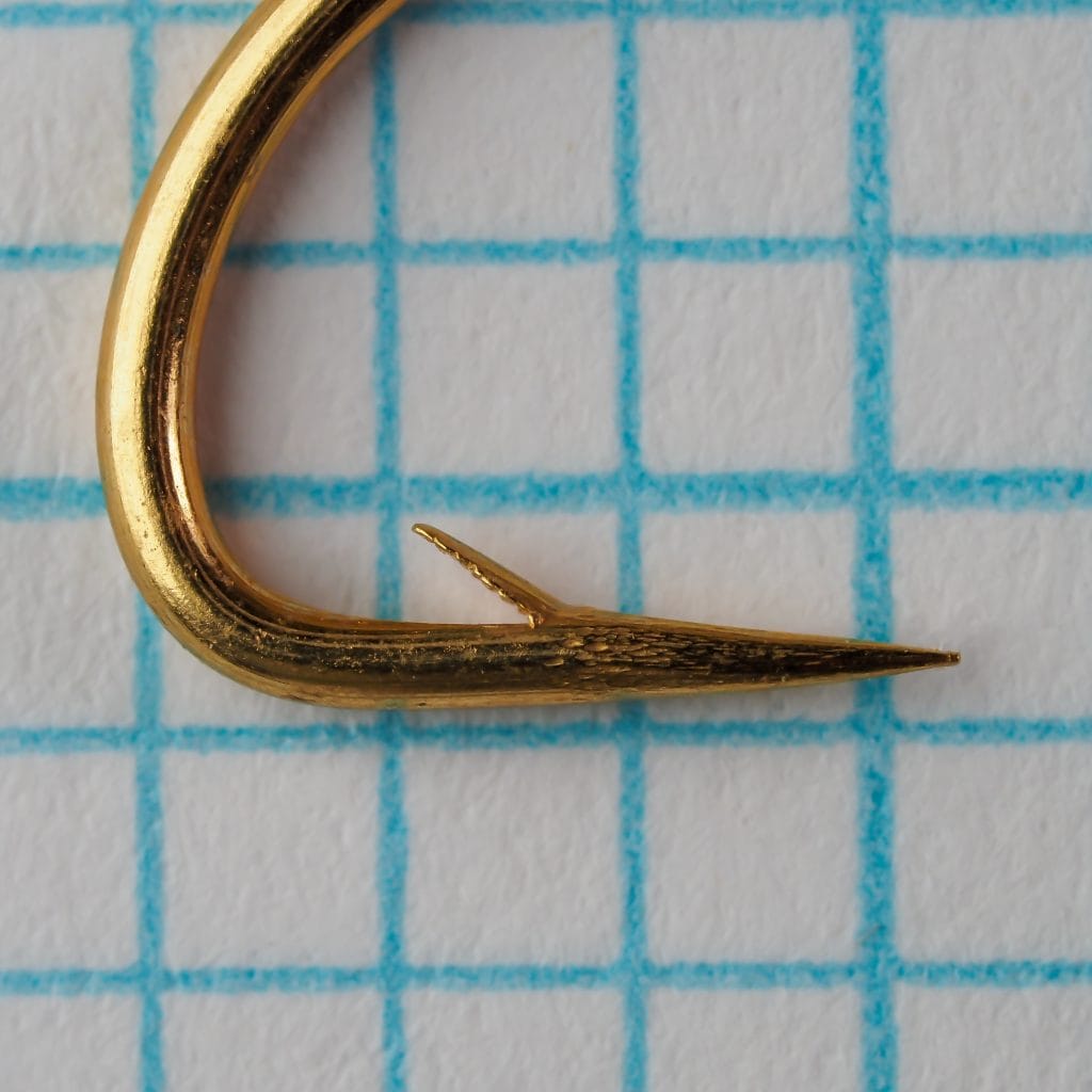 Allcocks L220 No. 4 — hook point and barb detail — gold-plated finish — close-up on measurement grid