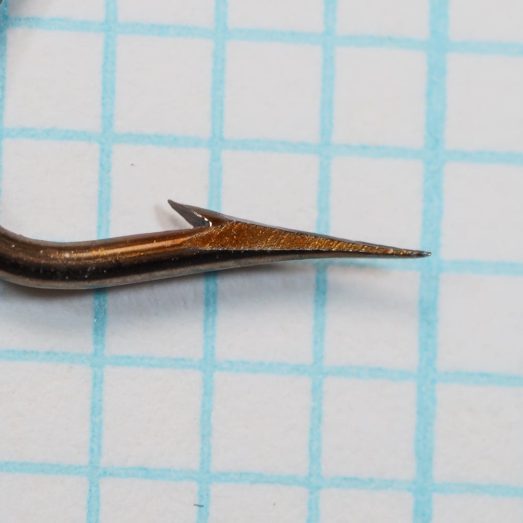 Mustad 3101 A — point detail showing superior point geometry — size 2/0 — bronzed finish