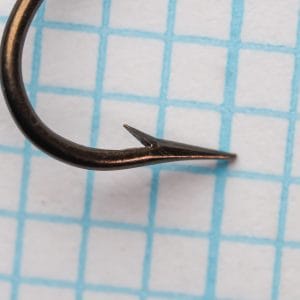 Mustad 3310 size 18 point and barb detail showing a long ground taper, nearly straight inner face, and small barb.
