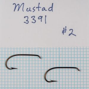 Two Mustad 3391 Sproat hooks, size #2, labeled specimen on graph paper grid.