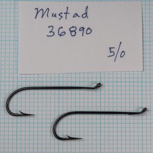 Mustad 36890 — two hooks on measurement grid — sizes 4/0 and 5/0 — scale reference