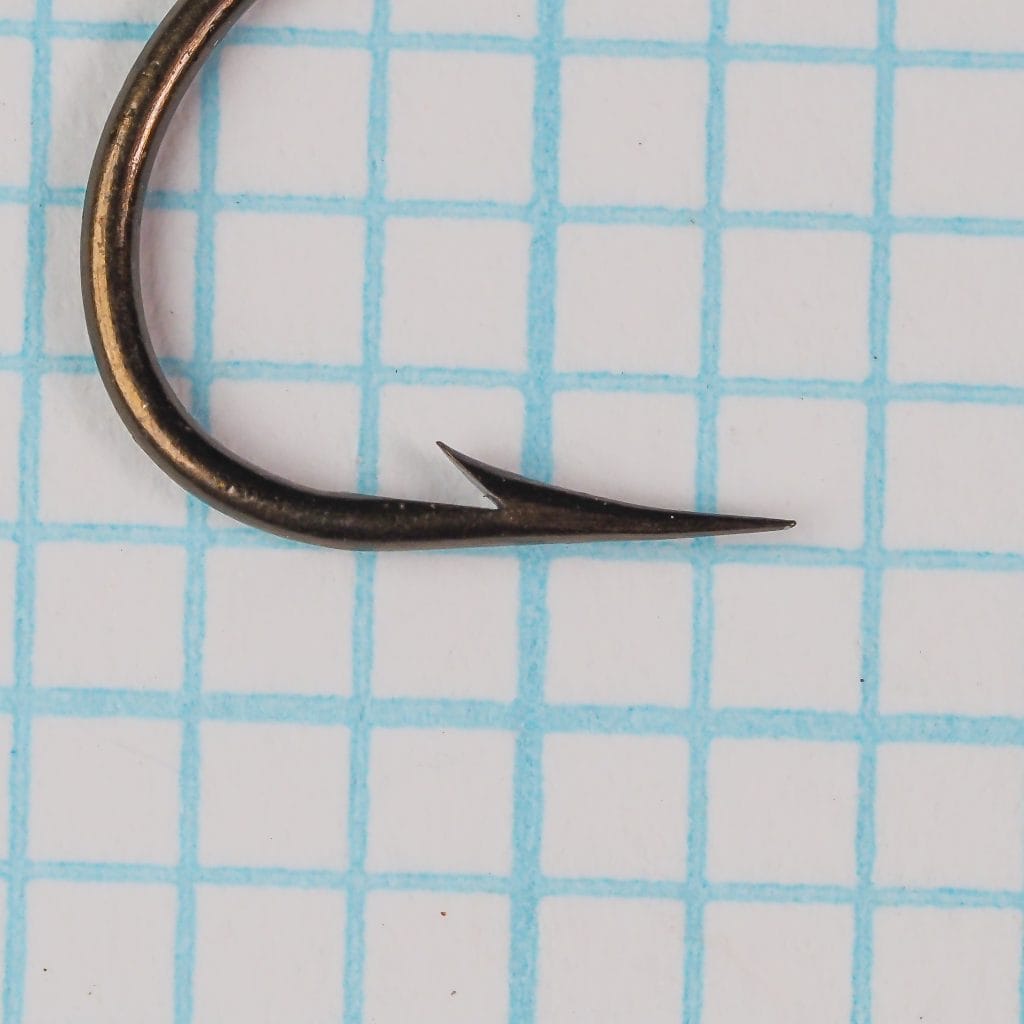 Mustad 3909 — close-up detail of hook point and barb — size 2 — bronzed hollow point