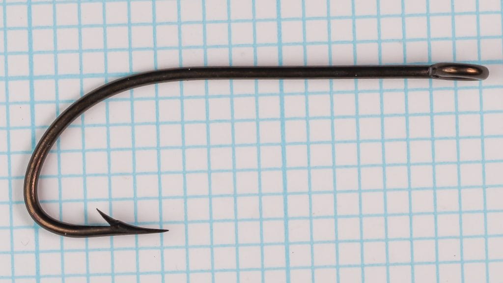 Mustad 4707 Extra-Strong Salmon Hook — Full side profile showing shank, bend, and eye — size 4/0 — ringed eye construction on measurement grid