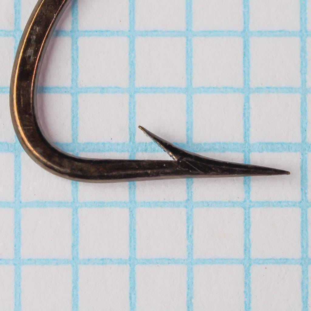 Mustad 506 Hook — point profile close-up showing hollow point geometry and barb angle — size 2/0 — blued finish