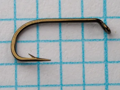 Mustad 56310 — full side profile showing Limerick bend geometry, ringed ball eye, and forged shank — bronzed finish — on measurement grid for scale