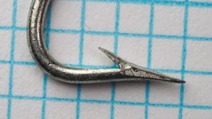 Mustad 7110 E — hook point close-up — size 3/0 — Superior point geometry showing tinned finish