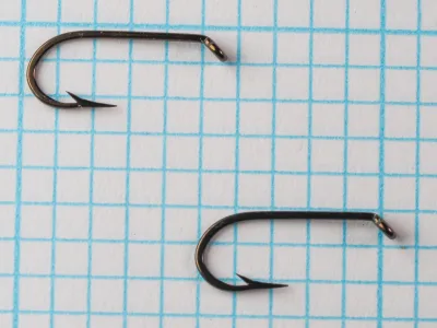 O. Mustad & Son Mustad 7947 B — overhead view of two complete hooks showing bend profile and eye construction — size 12 — round Viking bend, tapered ball eye