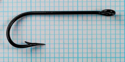 H. Milward & Sons Spear Pointed Kirby Hook — straight overhead view showing offset bend and ring eye — size 7/0 — japanned finish