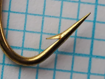 Herters No. 189 Hook point detail — close-up showing hollow point geometry and barb position — size 1/0 — gold plated