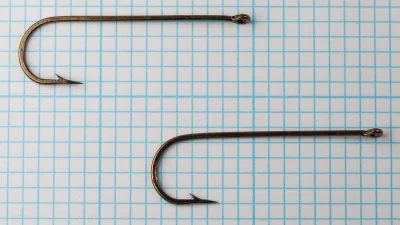 Herter's 423-R hooks comparative size, three specimens on blue grid, size 2 streamer hooks, bronzed