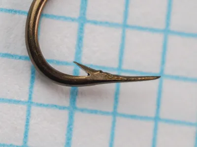 Mustad 3366 B Hook Point Detail — close-up of hook tip showing fine taper, barb angle, and bronze japanned finish, Size 6