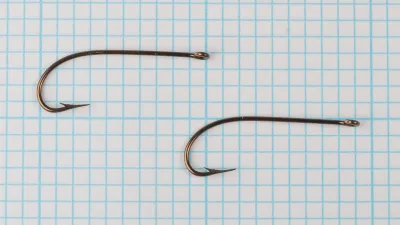 Mustad 3366 B Hook Pair — two hooks side-by-side on measurement grid showing production consistency, Size 6, bronze finish