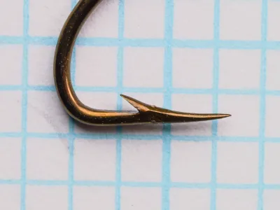 Mustad 3665A — single hook point detail — size 4 — hollow point geometry from side angle
