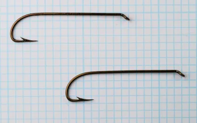 Mustad 3665A — two hooks at 10x magnification — size 4 — showing bend geometry and symmetry