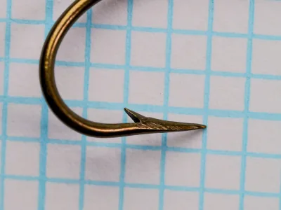 Mustad 3714 Carlisle Minnow Hook — close-up of hollow point and barb — size 2 — bronzed finish