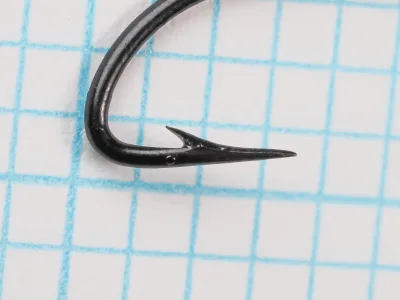 Mustad 3793 Chestertown Hook Point Detail — close-up of hollow point geometry showing concave inner face — Size 10 — measurement grid background