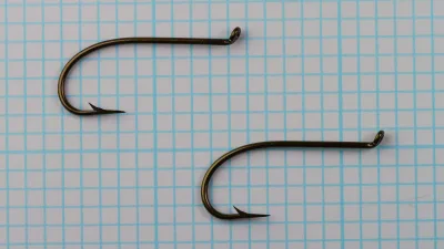 Mustad 3911 — comparative specimen photographs — two size No. 4 hooks — bronzed finish showing bend and eye variation