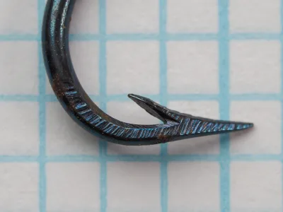 Mustad 4010 — point geometry side view — Size 7 — showing hollow point taper and curved-in design