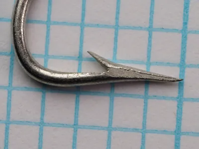 Mustad 7107 A tinned Limerick hook — side profile showing bend geometry and Superior point — size 3/0 — point taper visible.