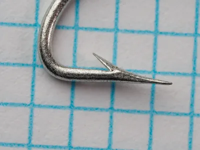 Mustad 8080 Hook — point and barb detail — size 6 — hollow point geometry visible on measurement grid