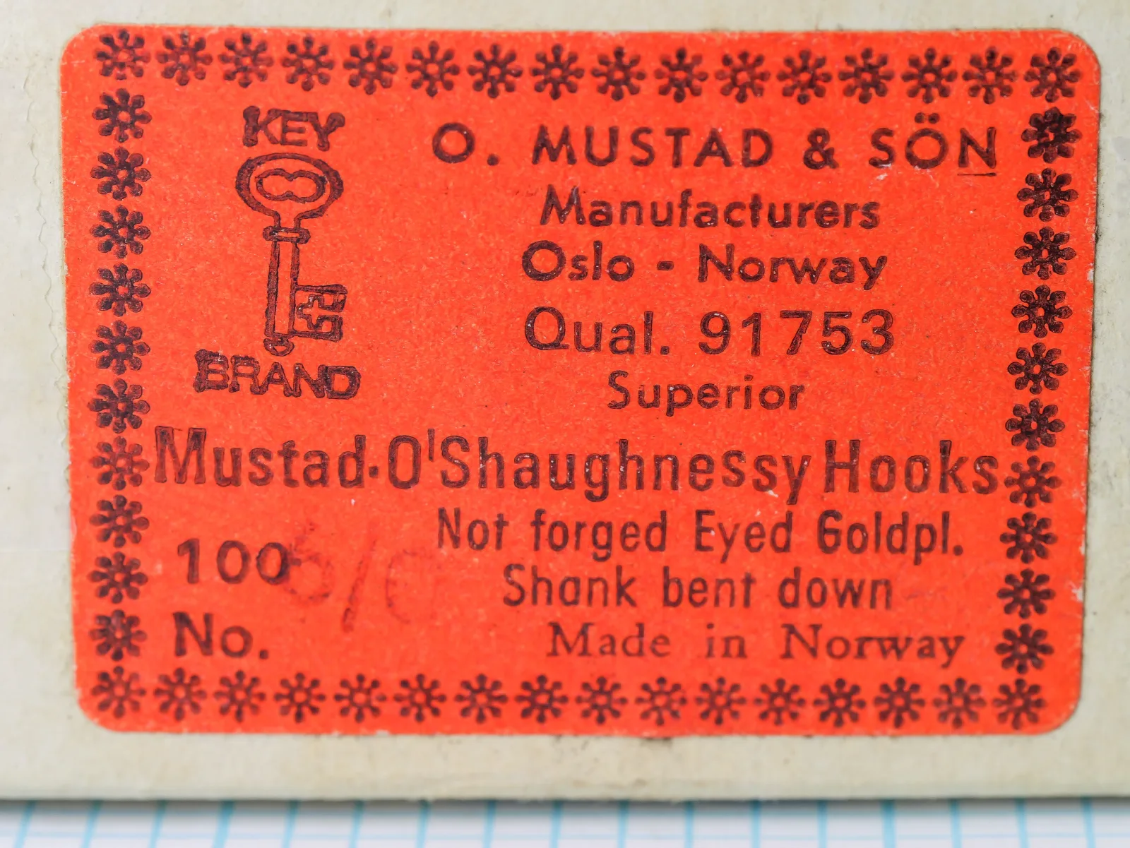 Red paper label with an asterisk border and a key device on a buff box, printed Qual. 91753 and Superior.