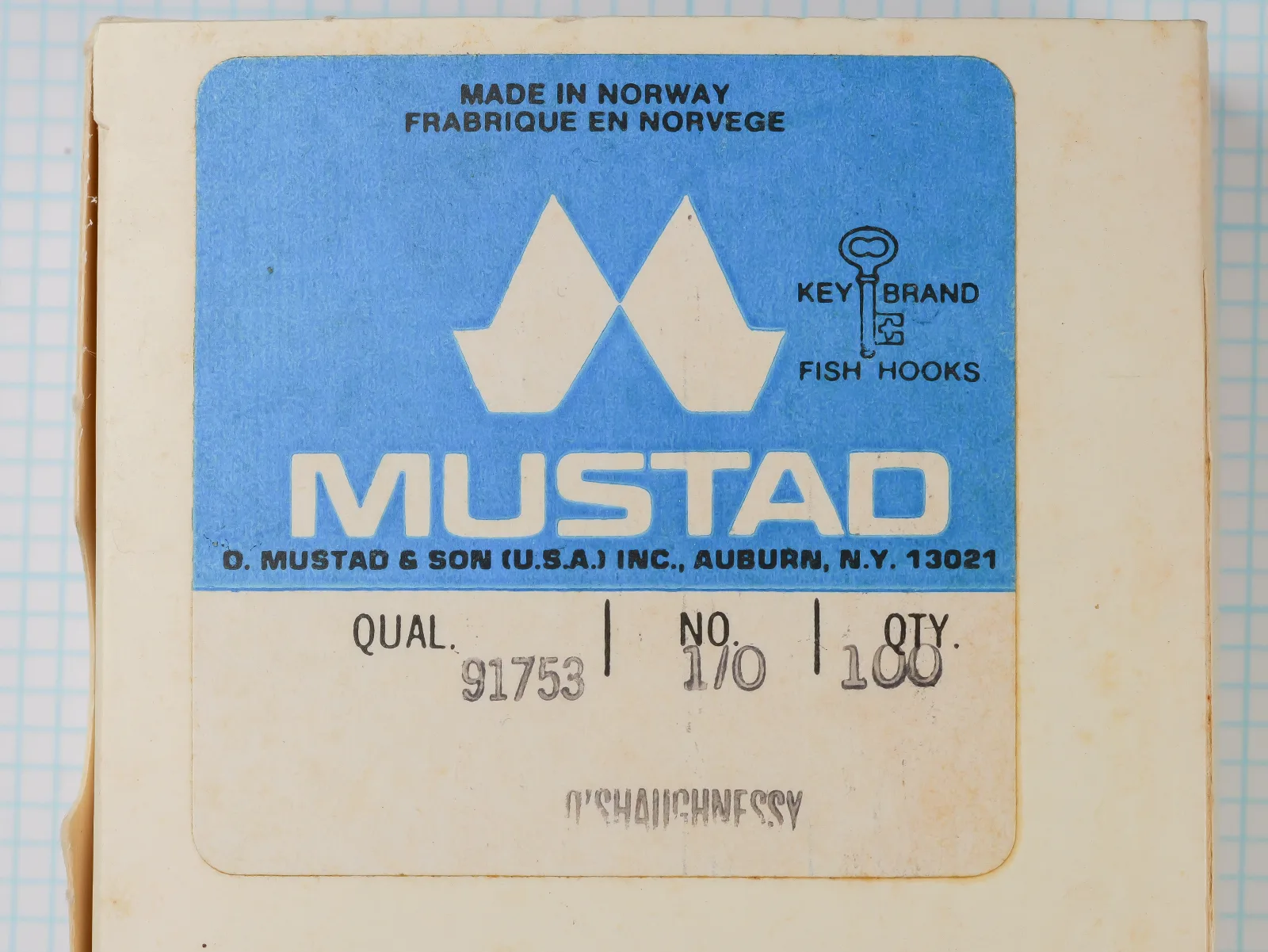 Mustad 91753 sales card — blue label with Double M logo and Auburn, N.Y. address — size 1/0 — 100-hook package