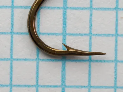 Mustad 94836 Viking Hook — side profile showing point geometry and bend curvature — size 6 — hollow point on measurement grid