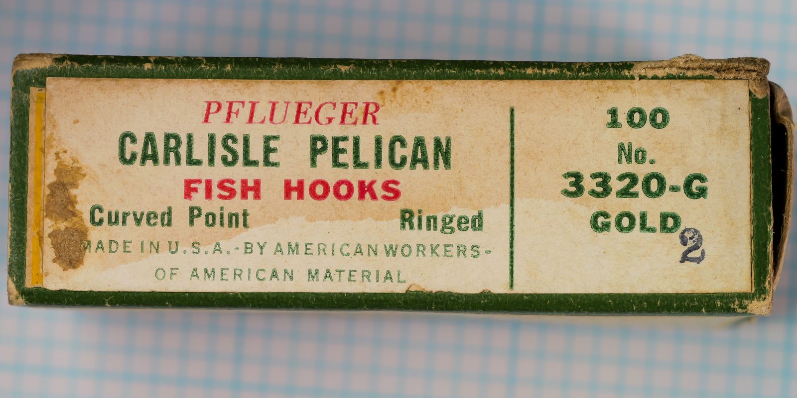Pflueger Carlisle Pelican 3320-G — front label of original kraft box with green wrap and gold border — size 2 — letterpress printing with bulldog logo