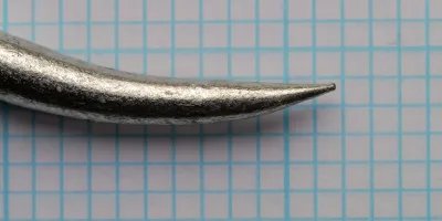 Mustad 3998 G — close-up point geometry — size 5/0 — barbless curved inward tip showing circle hook design
