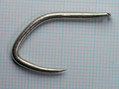 Mustad 3998 G — full hook profile — size 5/0 — tinned finish showing needle eye and extra-heavy wire gauge
