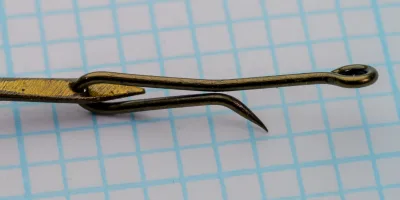 Mustad 3964 Sure Catch Hooks — full profile of double-hook assembly showing both hooks and extended metal shank — Size 5 — on measurement grid