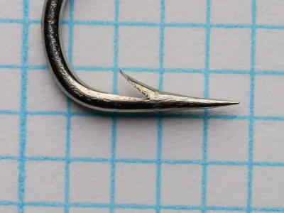 Allcocks S217 Sproat — point detail showing superior geometry and barb placement — size No. 2 — polished steel finish