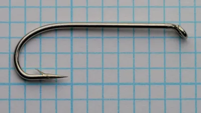 Allcocks S222 Sproat Hook — full shank and eye showing tapered eye ring construction — size 6 — bent at vertical angle on measurement grid